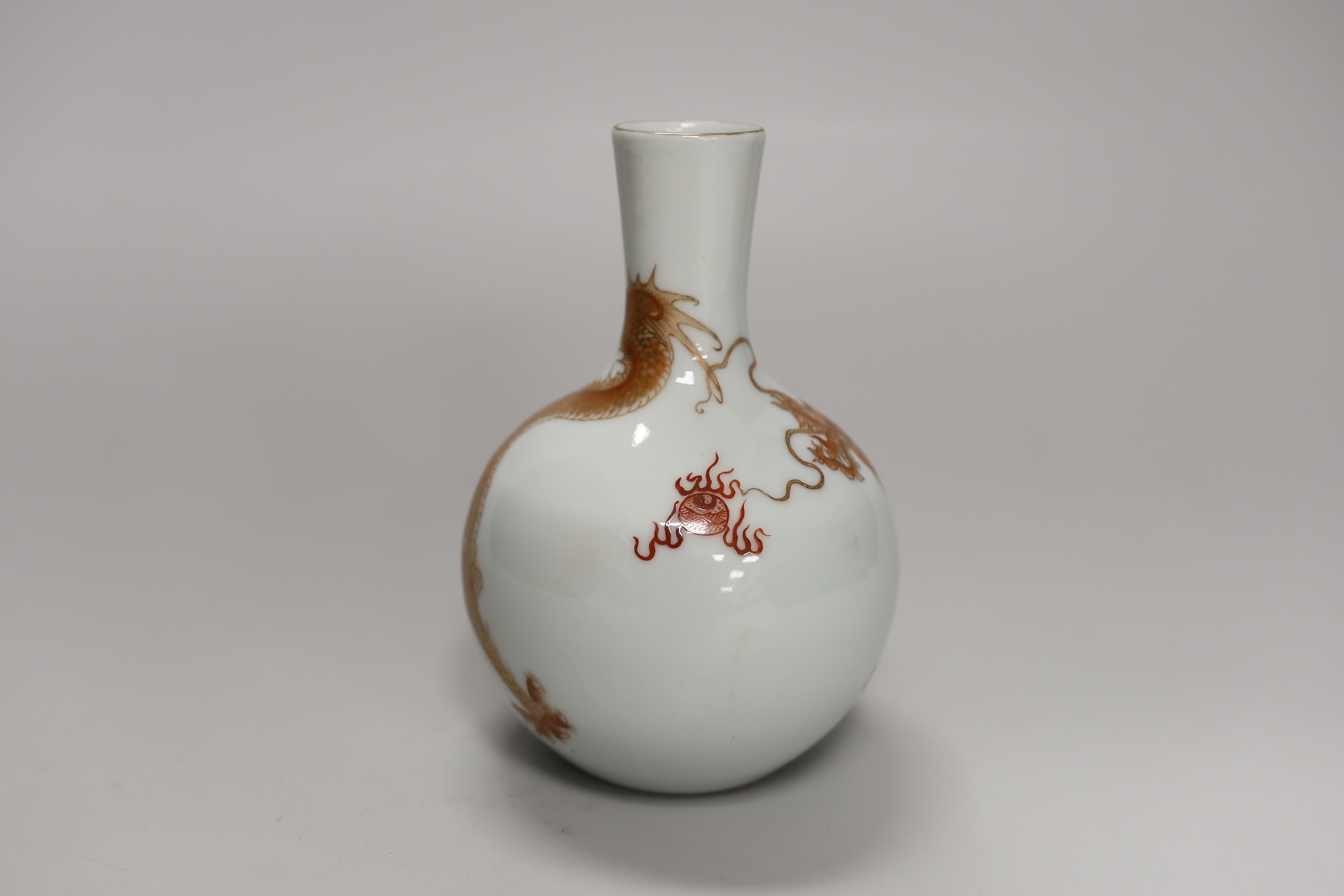 A Chinese rouge de fer decorated ‘dragon’ bottle vase, 14cm high (boxed)